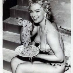 Showgirl having a pasta feast back stage